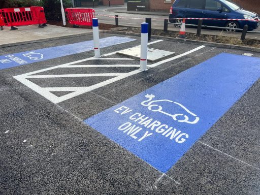 Blue parking space marked for electric vehicle charging only.